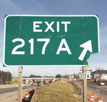 a green highway sign that says exit 217a