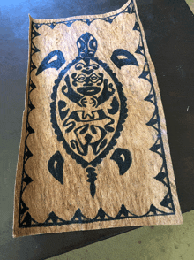 a piece of paper with a tribal turtle design