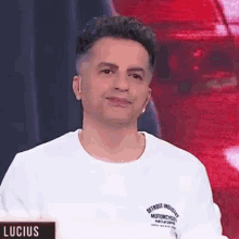 a man wearing a white t-shirt with the word lucius on it