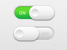 a green on and white off button are on a white surface