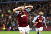 a soccer player wearing a maroon shirt with bk8 on the front