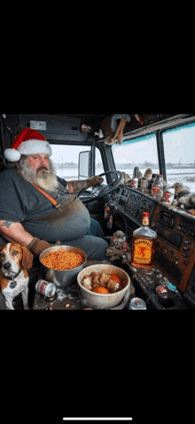 a man wearing a santa hat is sitting in the driver 's seat of a semi truck