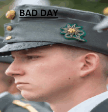 a man in a military uniform has a bad day sticker on his hat