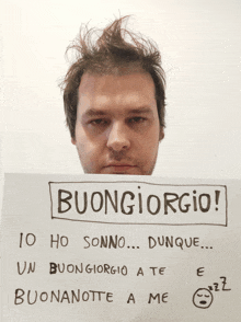 a man holding a sign that says buongiorgio on it