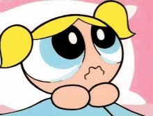 bubbles from the powerpuff girls is crying while laying in a bed .