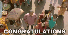 an aerial view of a crowd of people walking down a street with the words congratulations written above them .