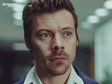a close up of a man 's face with the words harryxgf below him