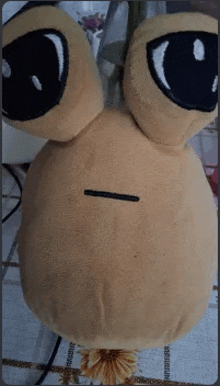 a stuffed animal is sitting on a table with a smiley face .