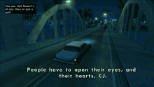 a blue car is driving down a street with the words people have to open their eyes and their hearts