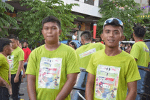 a group of men wearing green shirts that say festival on them