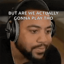 a man wearing headphones with the words but are we actually gonna play tho on the bottom