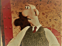 a cartoon character in a suit and tie is standing in front of a floral wallpaper