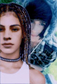 a woman with braids and a choker is standing next to a boy in a plaid shirt