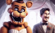 a man in a suit and bow tie is standing next to a teddy bear in a bride 's dress .