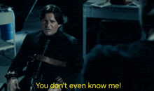 a man in a suit and tie is talking to another man who says you do n't even know me