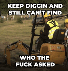 a man in a yellow vest is driving a cat digger