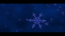 a purple snowflake is floating in the air on a blue background