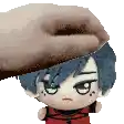 a hand is holding a stuffed animal on top of a stuffed animal .