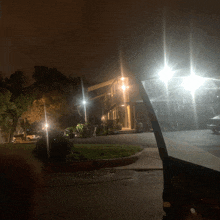 a car is parked in front of a house with lights on