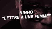 a close up of a man 's face with the words ninho lettre a une femme above it