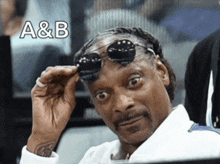 snoop dogg is wearing sunglasses with the letters a & b on the bottom