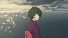 a girl in a red kimono stands in front of the ocean