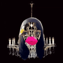 a chandelier with a woman 's face hanging from it