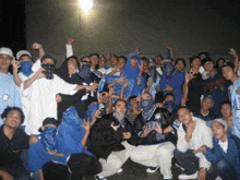 a group of young men wearing blue bandanas are posing for a picture with one man wearing a jersey with the number 08 on it