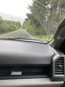 a dashboard of a car with a sticker on it that says ' warning ' on it