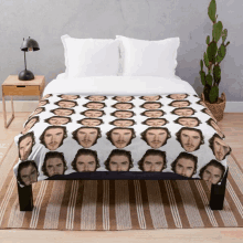 a bed with a blanket that has a pattern of men 's faces on it