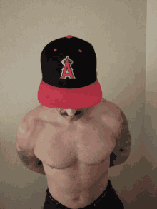 a man without a shirt is wearing a hat that says angels