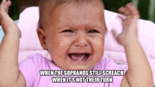 a baby in a pink shirt is crying with the caption when the sopranos still sreach when it 's not their turn