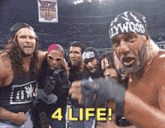 a group of men are posing for a picture and one of them is wearing a headband that says hollywood on it