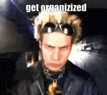 a blurry picture of a man with the words get organized on the bottom right