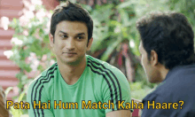 a man in a green shirt is talking to another man with pata hai hum match kaha haare written on the bottom