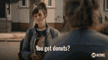 a woman is talking to a man and asking if he has donuts