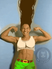 a girl with long hair is flexing her muscles while wearing a crop top and green shorts .