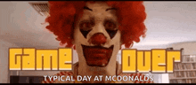 a clown in a red wig is standing in front of a mcdonald 's sign that says game over