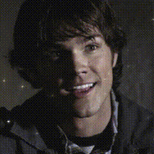 a close up of a man 's face with sparkles on it