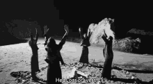 a black and white photo of a group of people on a beach with the words hear our prayers above them