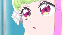 a close up of a girl 's face with pink and green eyes