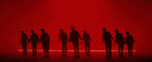 a group of people are standing in front of a red background that says snowman