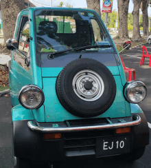 a green car with a license plate that says ej10