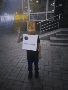 a boy wearing a box on his back that says brand cake on it