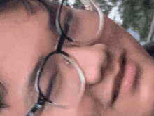 a close up of a person 's face with glasses