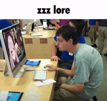 a man sits at a desk looking at a computer screen with zzz lore written above him