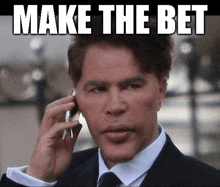 a man in a suit and tie talking on a cell phone with the words make the bet written above him