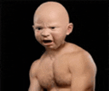 a bald baby without a shirt is crying .