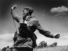 a black and white photo of a soldier in a field