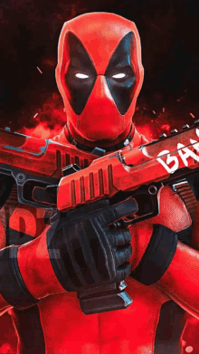 a deadpool holding a red gun with a chainsaw on it